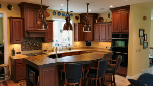 A kitchen with sunlight coming through a large window