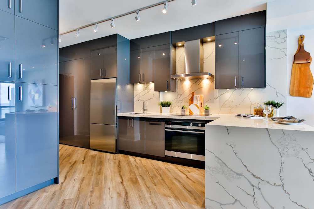 A white and black shiny kitchen with stylish under-cabinet lighting