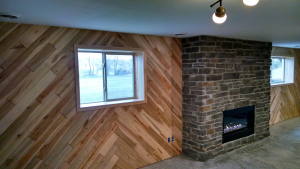 A house wall with a window and a fireplace by the side