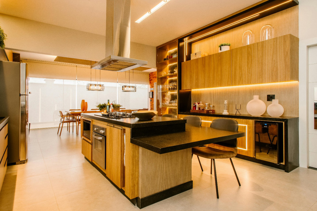 A remodeled kitchen using bamboo, and other wood with black countertops