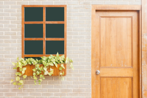 A light brown wooden door next to a window