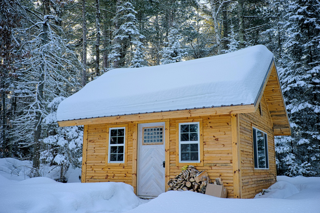 A cabin covered in snow 