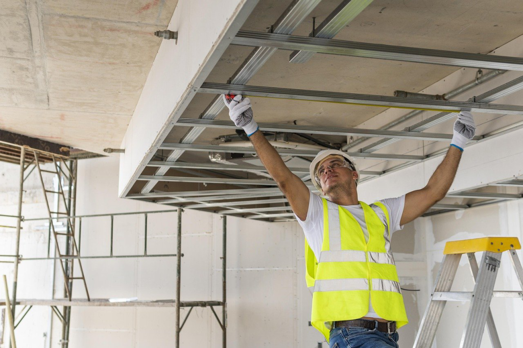 a construction worker setting a steel beam