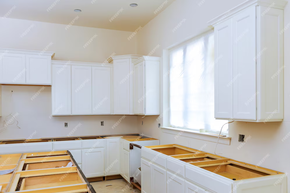 Blind cabinet, island drawers, and counter cabinets installed in a newly remodeled kitchen