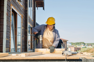 An image of a person wearing a yellow helmet working at a construction site