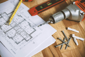 A detailed blueprint design with construction tools laid out for a custom home project.